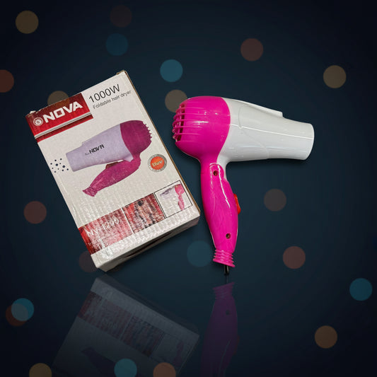 Pink and white hair dryer with packaging on a reflective surface