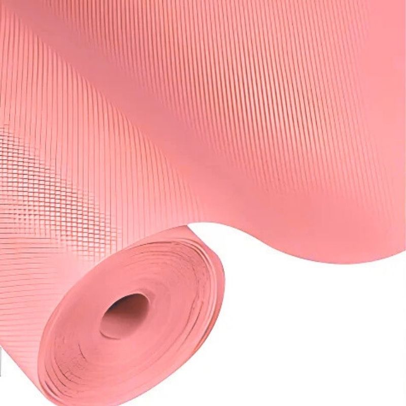 Roll of pink mesh fabric on a white background