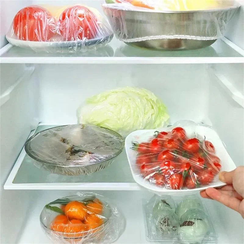 Fridge interior with various fruits and vegetables in plastic wrap