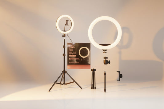 Ring light with stand, tripod, and packaging on a white background