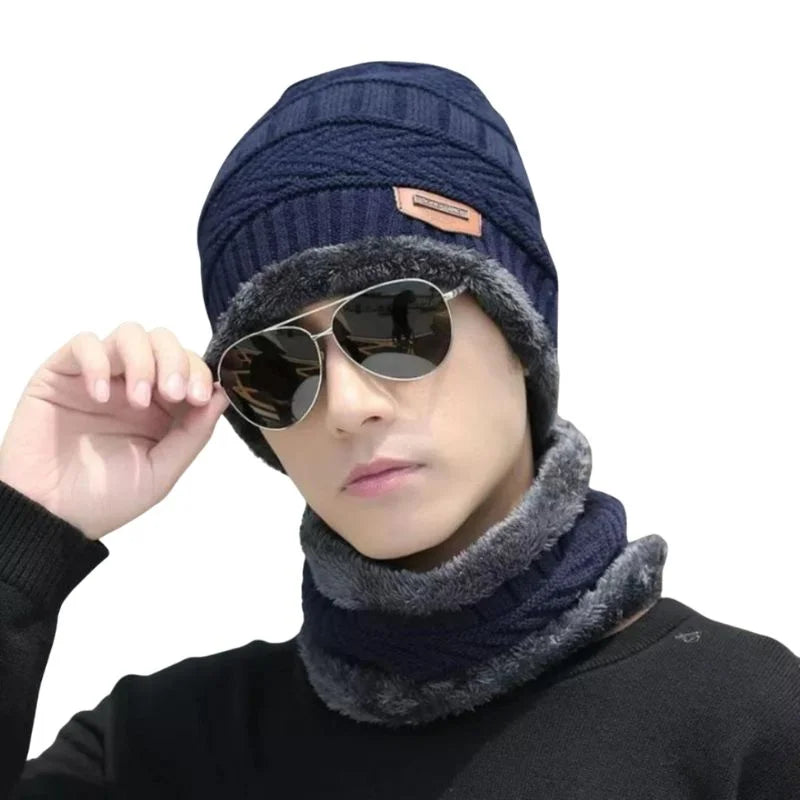 Hunt PK Person wearing a blue knit beanie and gray scarf with sunglasses on a white background