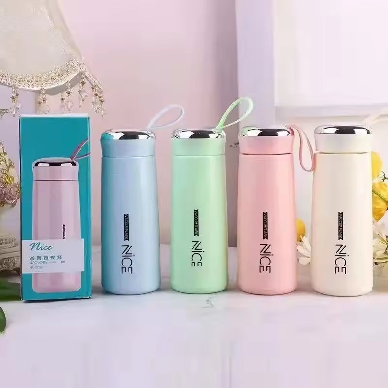 Hunt PK Set of colorful NICE thermos bottles on a white surface with a decorative background.