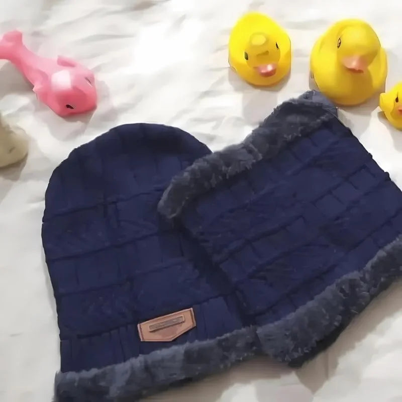 Hunt PK Blue quilted dog bed with gray trim on a white surface, surrounded by rubber duck toys. 